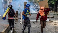 Masked opposition demonstrators take part in clashes with riot police ensuing an anti-government protest in Caracas, on July 26, 2017.
Venezuelans blocked off deserted streets Wednesday as a 48-hour opposition-led general strike aimed at thwarting embattled President Nicolas Maduro's controversial plans to rewrite the country's constitution got underway. / AFP PHOTO / FEDERICO PARRA        (Photo credit should read FEDERICO PARRA/AFP/Getty Images)