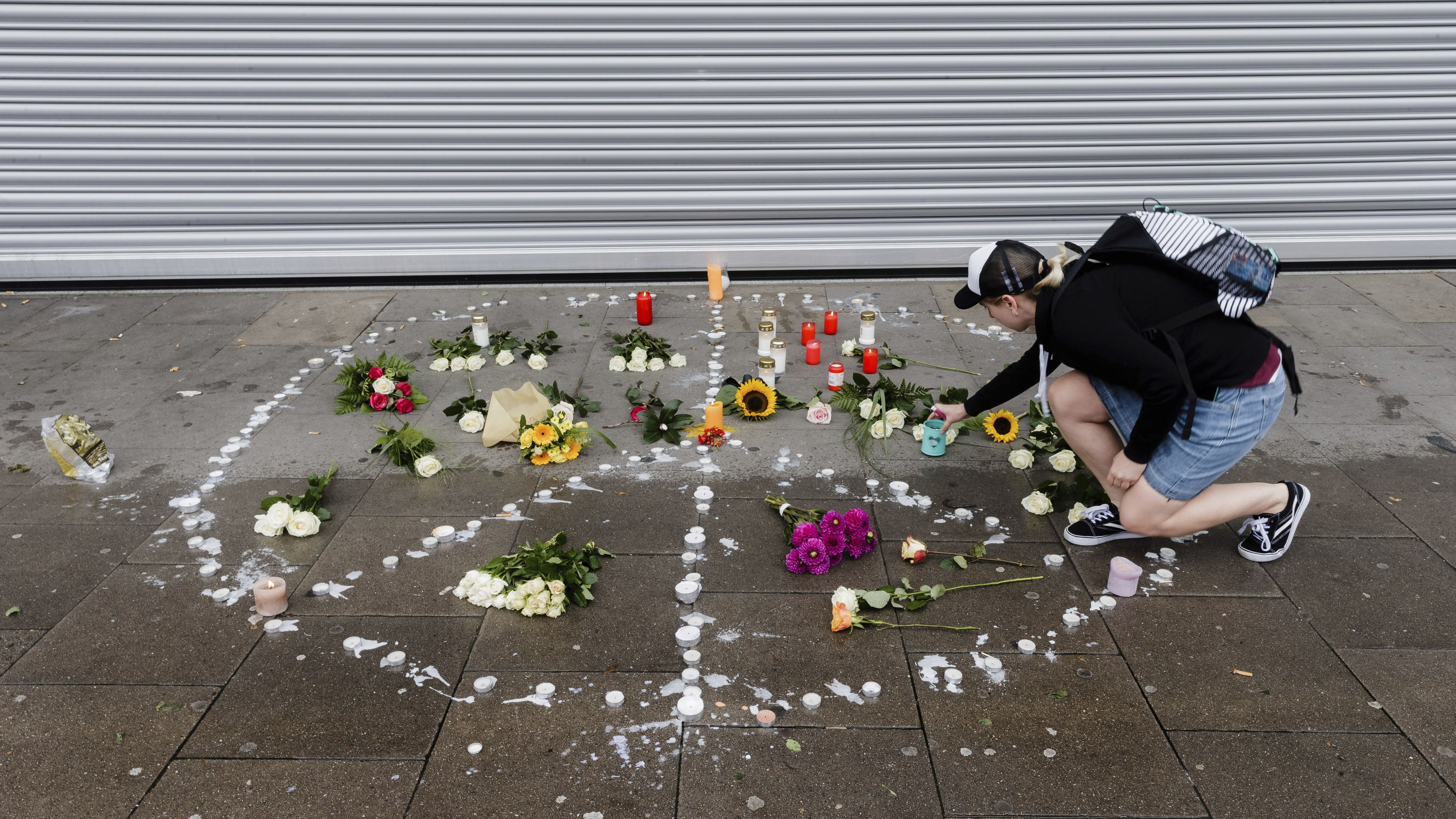 A woman places flowers  near the scene of the attack Saturday in Hamburg. 