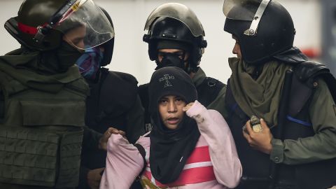 An anti-government activist is arrested Friday during clashes in the capital, Caracas.