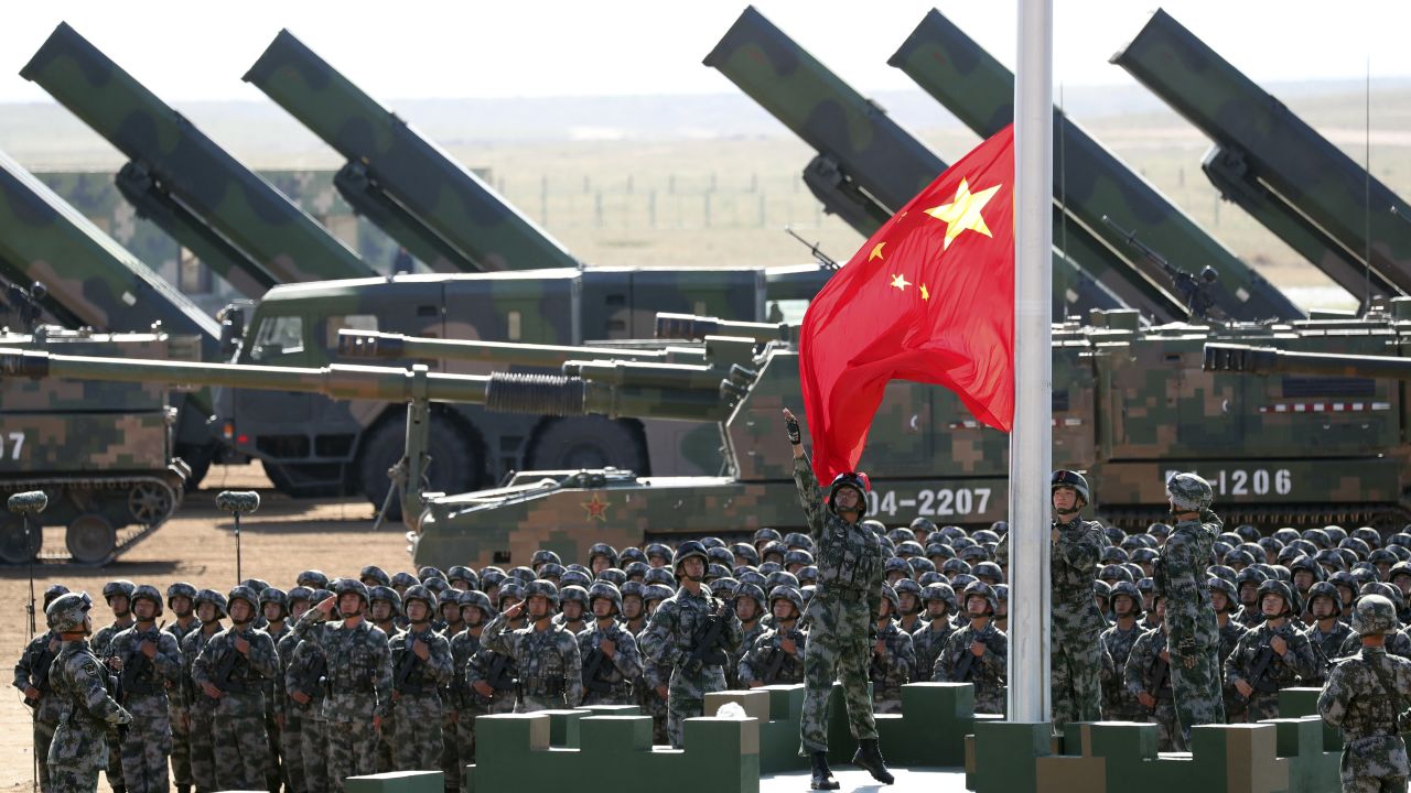Troops raise the flag on Sunday.