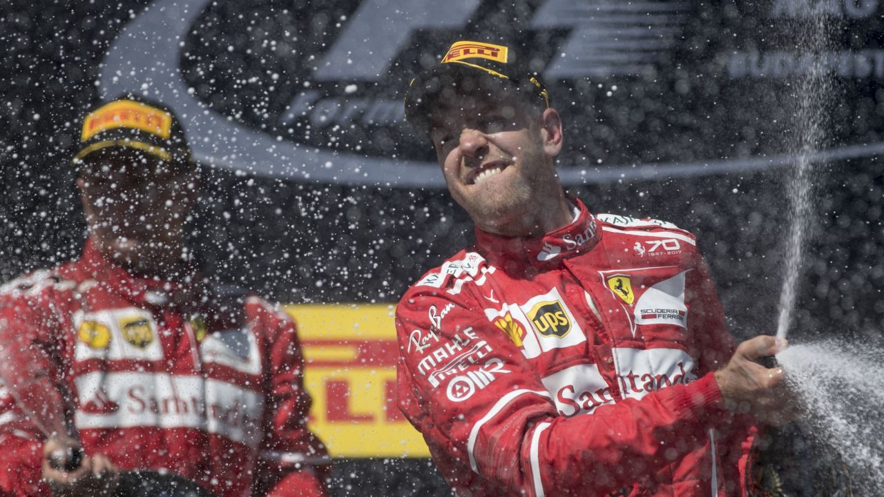 Sebastian Vettel celebrates on the podium after a Ferrari one-two in Hungary.
