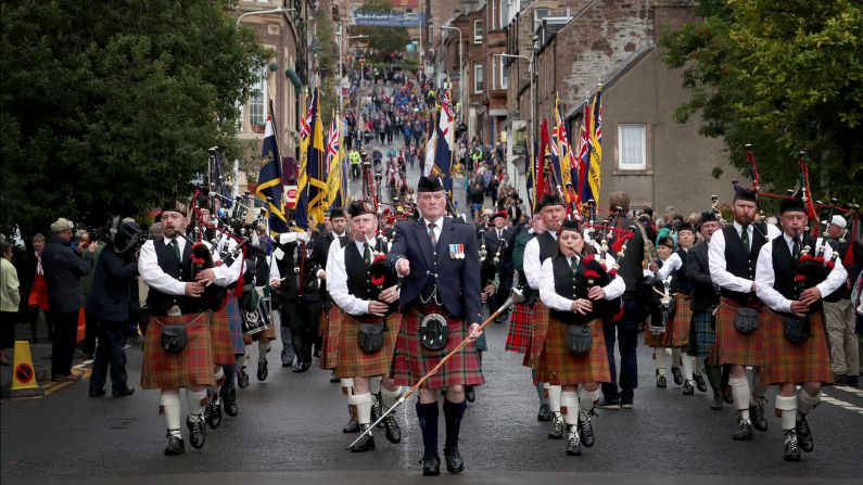 Veterans and active duty soldiers from The Royal Regiment of Scotland march in a parade in Crieff, Scotland, on Sunday, July 30.