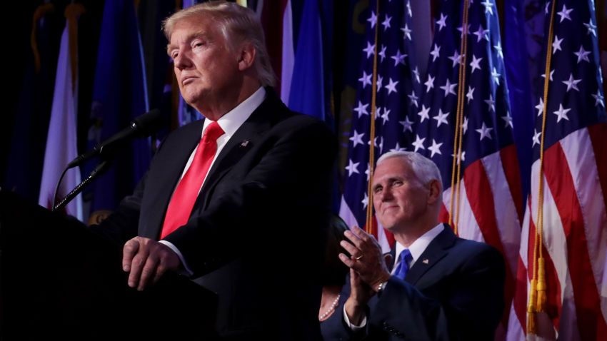 Republican president-elect Donald Trump delivers his acceptance speech as Vice president-elect Mike Pence looks on during his election night event at the New York Hilton Midtown in the early morning hours of November 9, 2016 in New York City. Donald Trump defeated Democratic presidential nominee Hillary Clinton to become the 45th president of the United States.