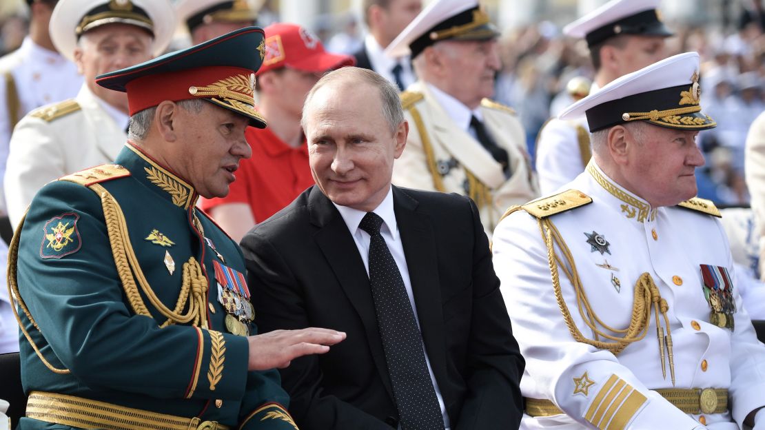 Russian Defense Minister Sergei Shoigu, President Vladimir Putin, and the commander-in-chief of the Russian Navy Adm. Vladimir Korolev review a naval parade in St. Petersburg.