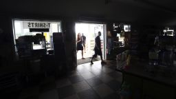 Customers enter the darkened Island Convenience Store in Rodanthe on Hatteras Island on Friday, July 28, 2017. Non-residents were asked to evacuate the island and neighboring Ocracoke Island due to a loss of electrical power. 