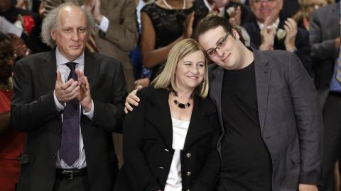 Nashville Mayor Megan Barry is hugged by her son, Max, as her husband, Bruce, applauds after she was sworn into office in Nashville.
