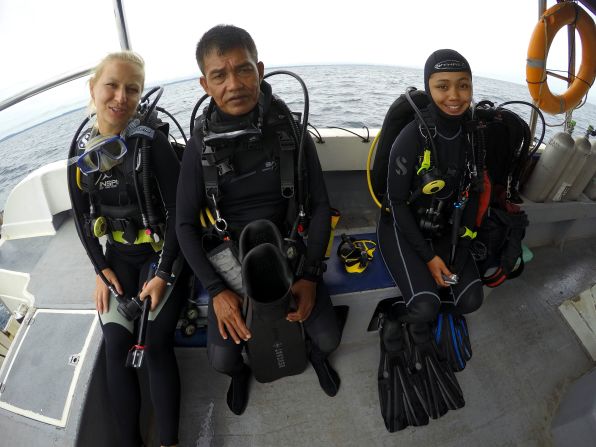 Abdullah (center) is on a mission to sketch  shipwrecks off the coast of Brunei.