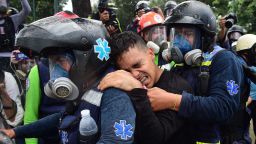 A wounded anti-government activist is carried away by medics during clashes with the police which erupted during a protest against the elections for a Constituent Assembly in Caracas on July 30, 2017.Deadly violence erupted around the controversial vote, with a candidate to the all-powerful body being elected shot dead and troops firing weapons to clear protesters in Caracas and elsewhere. / AFP PHOTO / Ronaldo SCHEMIDT        (Photo credit should read RONALDO SCHEMIDT/AFP/Getty Images)
