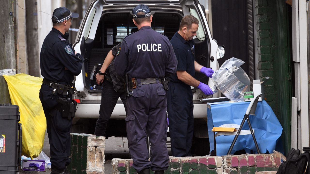 Police tape up evidence outside a house in the inner Sydney suburb of Surry Hills on July 30.