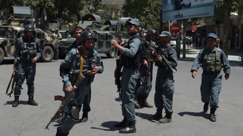 Afghan police officers arrive at the site of a suicide blast in Kabul on July 31.