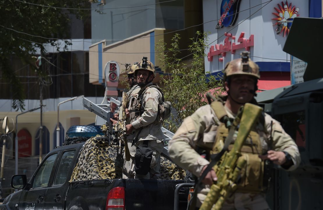 Afghan security personnel arrive at the site of a suicide blast in Kabul on July 31.