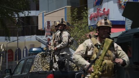 Afghan security personnel arrive at the site of a suicide blast in Kabul on July 31.