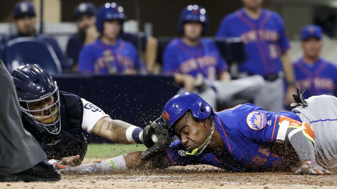 New York Mets outfielder Yoenis Cespedes slides into home plate, beating the tag from San Diego catcher Hector Sanchez during a Major League Baseball game on Tuesday, July 25.
