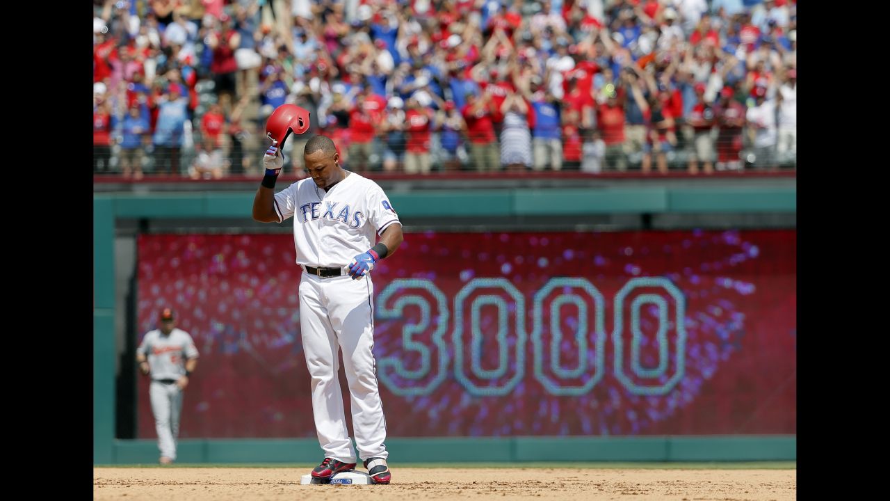 Texas' Adrian Beltre tips his helmet to the cheering home crowd after collecting his 3,000th career hit on Sunday, July 30. He is the 31st player in history to reach the milestone.