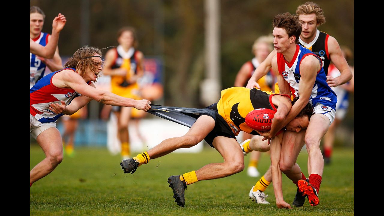 Dandenong's William Hamill is tackled by players of the Gippsland Power during an Australian rules football match in Melbourne on Saturday, July 29.