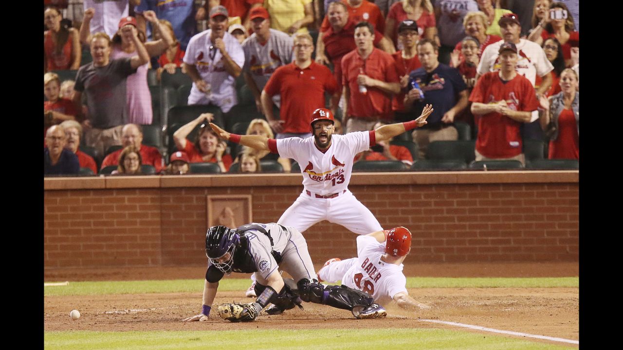 Matt Carpenter calls St. Louis teammate Harrison Bader safe as Bader scores the game-winning run against Colorado on Tuesday, July 25. Bader scored on a sacrifice fly by Jedd Gyorko.