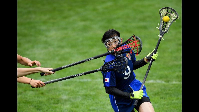 Japanese lacrosse player Sachiko Komine avoids two British players at the World Games on Thursday, July 27.