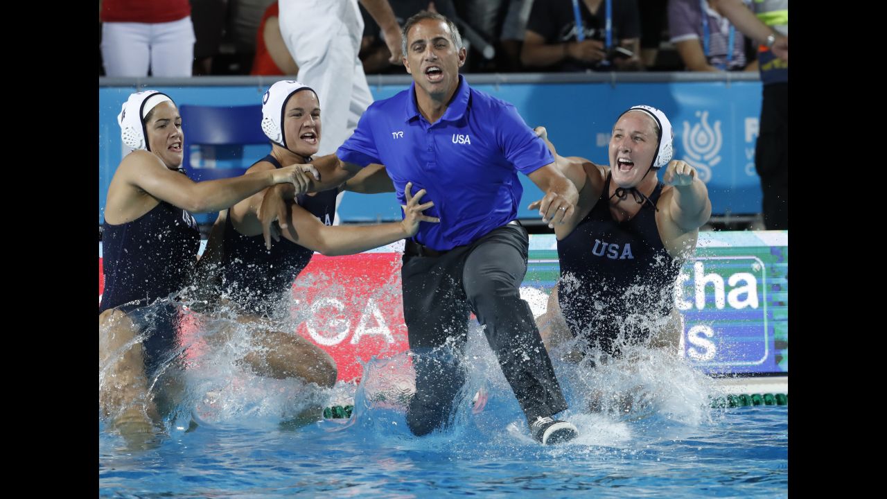US water polo coach Adam Krikorian jumps into the pool after the Americans defeated Spain in the final of the FINA World Championships on Friday, July 28. 
