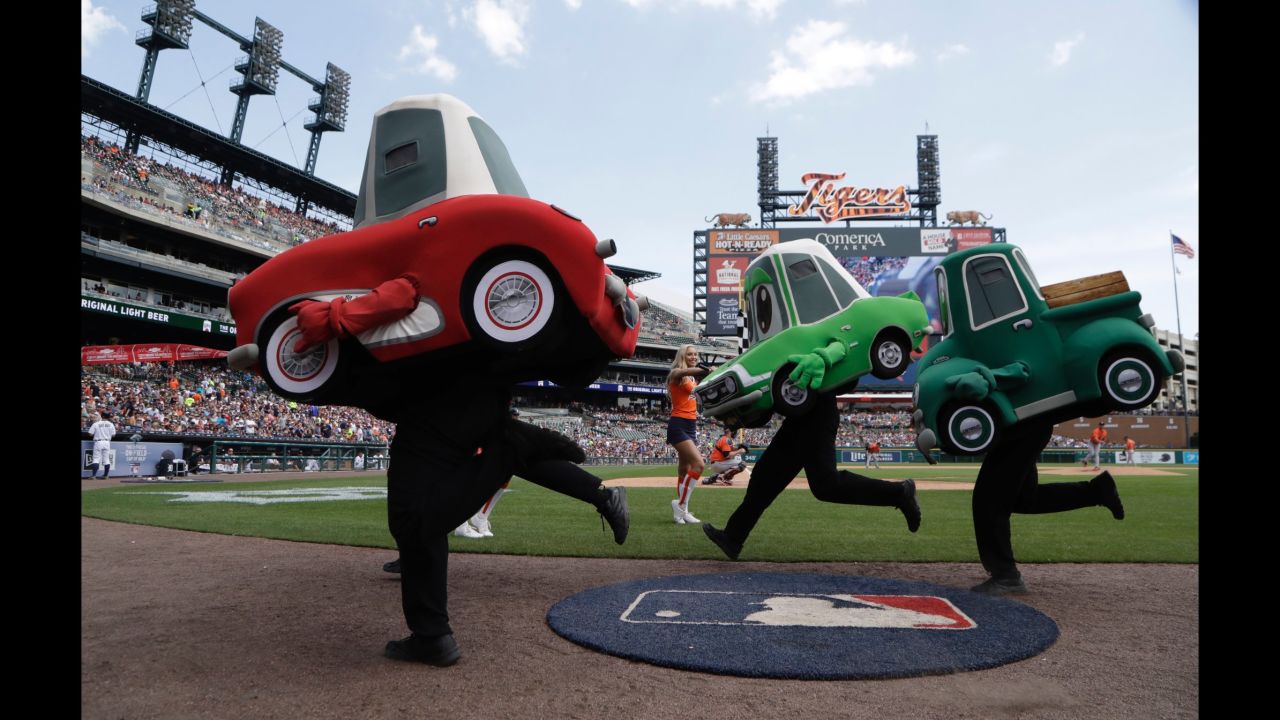 The Motor City Wheels race during the fourth inning of a Major League Baseball game in Detroit on Sunday, July 30.