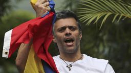 FILE - In this Saturday, July 8, 2017, file photo, Venezuela's opposition leader Leopoldo Lopez holds a national flag as he greets supporters outside his home in Caracas, Venezuela, following his release from prison and being placed under house arrest after more than three years in military lockup. Allies of two Venezuelan opposition leaders say Lopez and Antonio Ledezma have been taken by authorities from the homes where they were under house arrest. Video posted on the Twitter account of Lopez's wife early Tuesday, Aug. 1, shows a man being taken away from a Caracas home by state security agents. (AP Photo/Fernando Llano, File)