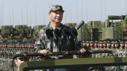 In this photo released by Xinhua News Agency, Chinese President Xi Jinping stands on a military jeep as he inspects troops of the People's Liberation Army during a military parade to commemorate the 90th anniversary of the founding of the PLA at Zhurihe training base in north China's Inner Mongolia Autonomous Region, Sunday, July 30, 2017. China's military has the "confidence and capability" to bolster the country's rise into a world power, President Xi Jinping said Sunday as he oversaw a large-scale military parade meant to show off the forces at his command to foreign and domestic audiences. (Li Gang/Xinhua via AP)