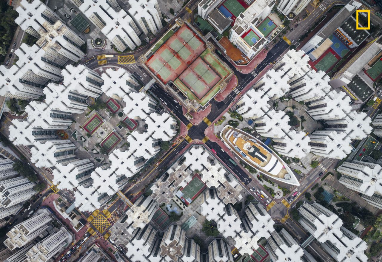 <strong>2nd Prize City Category -- "Walled City #08":</strong> The second prize winner in the city category of the <a href="http://travel.nationalgeographic.com/photographer-of-the-year-2017/" target="_blank" target="_blank">2017 National Geographic Travel Photographer of the Year Contest </a>is <a href="http://yourshot.nationalgeographic.com/profile/1288370/" target="_blank" target="_blank">Andy Yeung</a>. Yeung says: "The Kowloon Walled City was the densest place on Earth. Hundreds of houses stacked on top of each other enclosed in the center of the structure. Many didn't have access to open space. This notorious city was finally demolished in 1990s. However, if you look hard enough, you will notice that the city is not dead. Part of it still exists in many of current high density housing apartments. I hope this series can get people to think about claustrophobic living in Hong Kong from a new perspective."