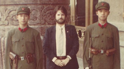 Booth stands between two Chinese soldiers of the People's Liberation Army outside Beijing's Great Hall of the People in 1981. 