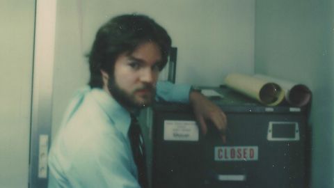Booth was assigned to Geneva, Switzerland, in 1977 as a US State Department security officer at the SALT nuclear weapons arms reduction negotiations with the Soviet Union. Shown here in a tongue-in-cheek photo, Booth posed next to a high-security file cabinet containing top secret code word information about US nuclear weapons capabilities.