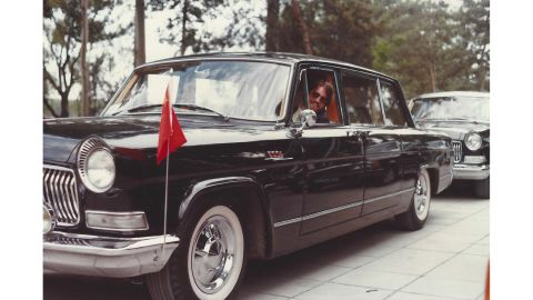 Booth poses behind the wheel of a Chinese diplomatic car in Beijing in 1981. 