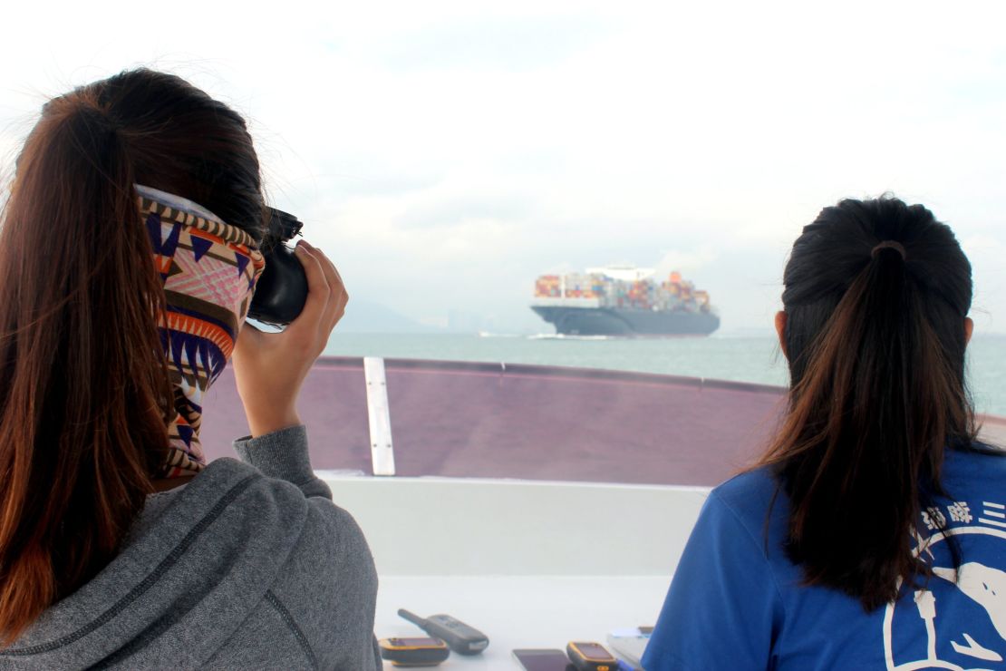 Charlotte Lau and Viena Mak from the Hong Kong Dolphin Conservation Society survey the waters near Lantau Island. 