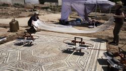 Archaeologists work on a mosaic on July 31, 2017, on the archaeological antiquity site of Sainte-Colombe, near Vienne, eastern France.
Remains of an entire neighbourhood of the Roman city of Vienne have been uncovered in Sainte-Colombe, with lavish residences decorated with mosaics, a philosophy school and shops. The dig of the site, discovered prior to housing construction on a parcel of 5000 m2, began in April 2017 and was due to last six months, but have been extended to December 15, 2017, after the site was classified as an "exceptional discovery" by the French Culture Minsitry. / AFP PHOTO / JEAN-PHILIPPE KSIAZEK        (Photo credit should read JEAN-PHILIPPE KSIAZEK/AFP/Getty Images)