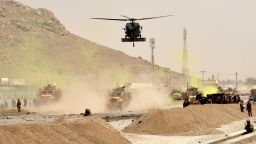 A US black hawk helicopter flies over the site of a Taliban suicide attack in Kandahar on August 2, 2017. 
A Taliban suicide bomber on August 2 rammed a vehicle filled with explosives into a convoy of foreign forces in Afghanistan's restive southern province of Kandahar, causing casualties, officials said. "At around noon a car bomb targeted a convoy of foreign forces in the Daman area of Kandahar," provincial police spokesman Zia Durrani told AFP.
 / AFP PHOTO / JAVED TANVEER        (Photo credit should read JAVED TANVEER/AFP/Getty Images)