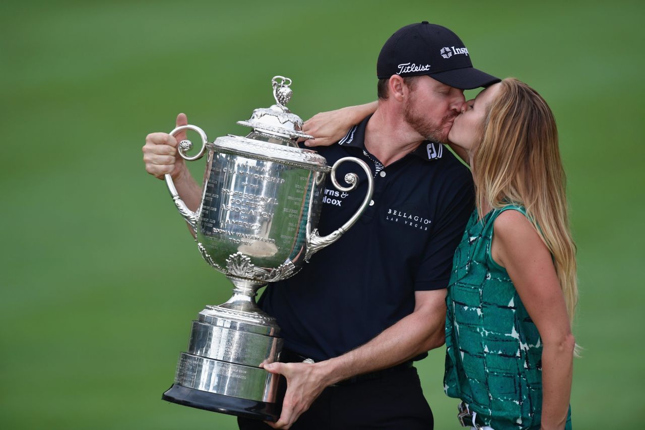Erin Walker kisses husband Jimmy Walker after he claimed the US PGA Championship in 2016. She spends 30 weeks of the year traveling the world as he participates on the PGA Tour.