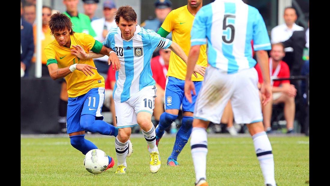 Neymar battles Argentina's Lionel Messi during an international friendly in June 2012. The two would later become teammates at Barcelona.