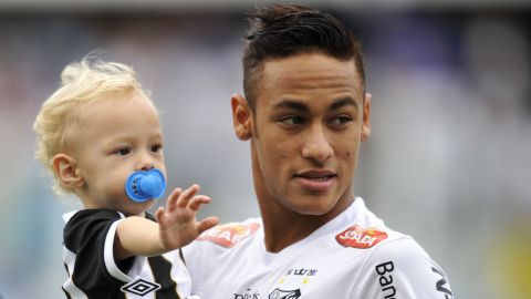 Neymar holds his son, Davi Lucca, at a Santos match in May 2013.