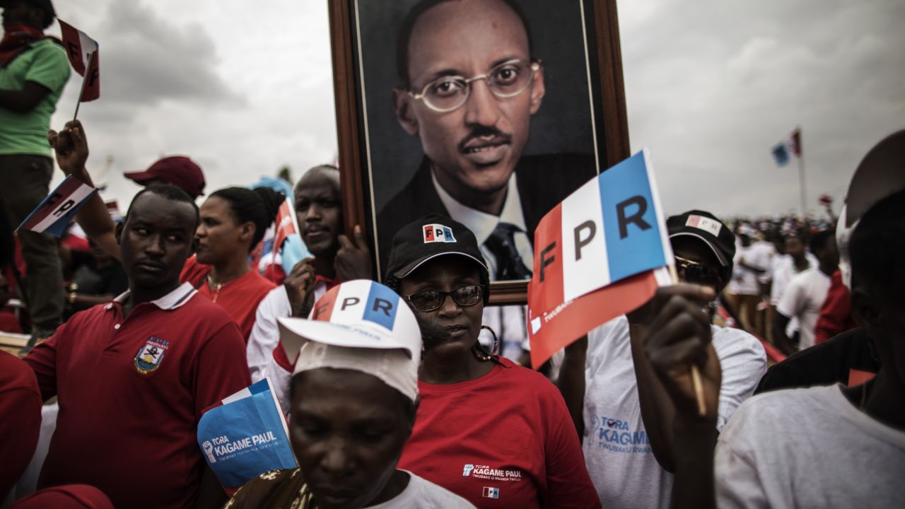 Supporters of President Paul Kagame carry a photograph of him at a rally in Kigali, on August 2, 2017.