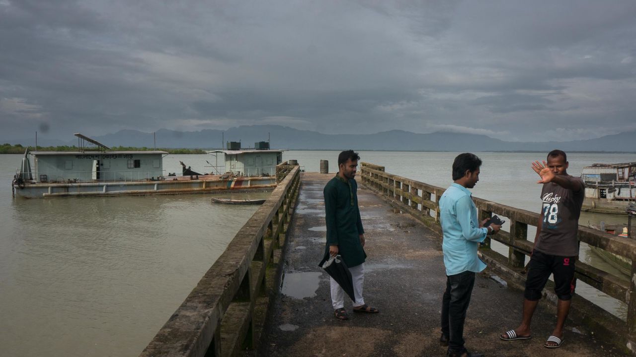 An off-duty boarder guard blocks his face from being photographed. The Naf River, which divides Bangladesh and Myanmar, is perforated by illegal vessels carrying drugs and Rohingya refugees. Officials here distrust journalists.
