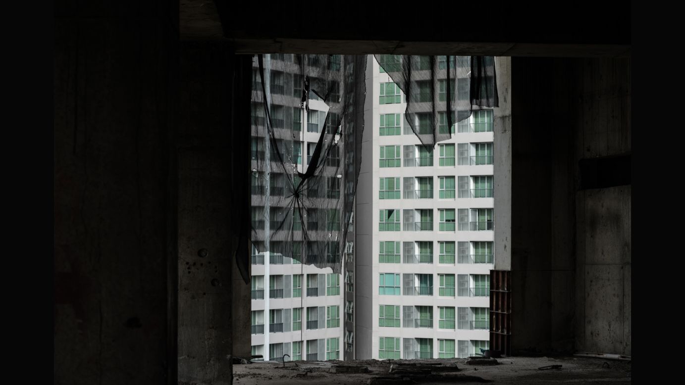 A neighboring building seen from inside the deserted structure.