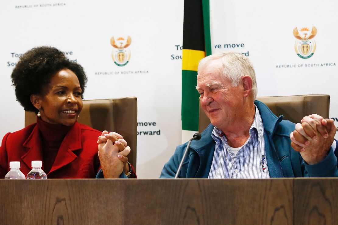 Malcolm McGown clasps hands with South African Foreign Minister Maite Nkoana-Mashabane during a press conference Thursday in Pretoria.