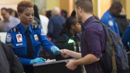 A TSA Agent checks the ID's of passengers as they pass through a security checkpoint on the way to their flights at Reagan National Airport in Arlington, Virginia, December 23, 2015. More than 100 million holiday travelers are expected to travel in the US during the last weeks of the year according to the American Automobile Association. AFP PHOTO / SAUL LOEB / AFP / SAUL LOEB        (Photo credit should read SAUL LOEB/AFP/Getty Images)