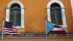 SAN JUAN, PUERTO RICO - JUNE 30:  An American flag and Puerto Rican flag fly next to each other in Old San Juan a day after the Puerto Rican Governor Alejandro Garcia Padilla gave a televised speech regarding the governments $72 billion debt on June 30, 2015 in San Juan, Puerto Rico.  The Governor said in his speech that the people will have to sacrifice and share in the responsibilities for pulling the island out of debt.  (Photo by Joe Raedle/Getty Images)