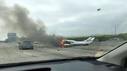 Drew Hoffman drove past a small plane that crashed on the 405 near John Wayne Airport in Santa Ana, California, on Friday.