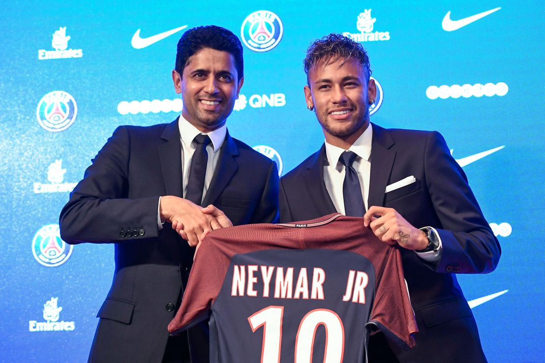 Neymar (R) poses with his jersey next to Paris Saint Germain's (PSG) Qatari president Nasser Al-Khelaifi during a press conference on August 4, 2017.