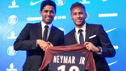 Neymar (R) poses with his jersey next to Paris Saint Germain's (PSG) Qatari president Nasser Al-Khelaifi during a press conference on August 4, 2017.