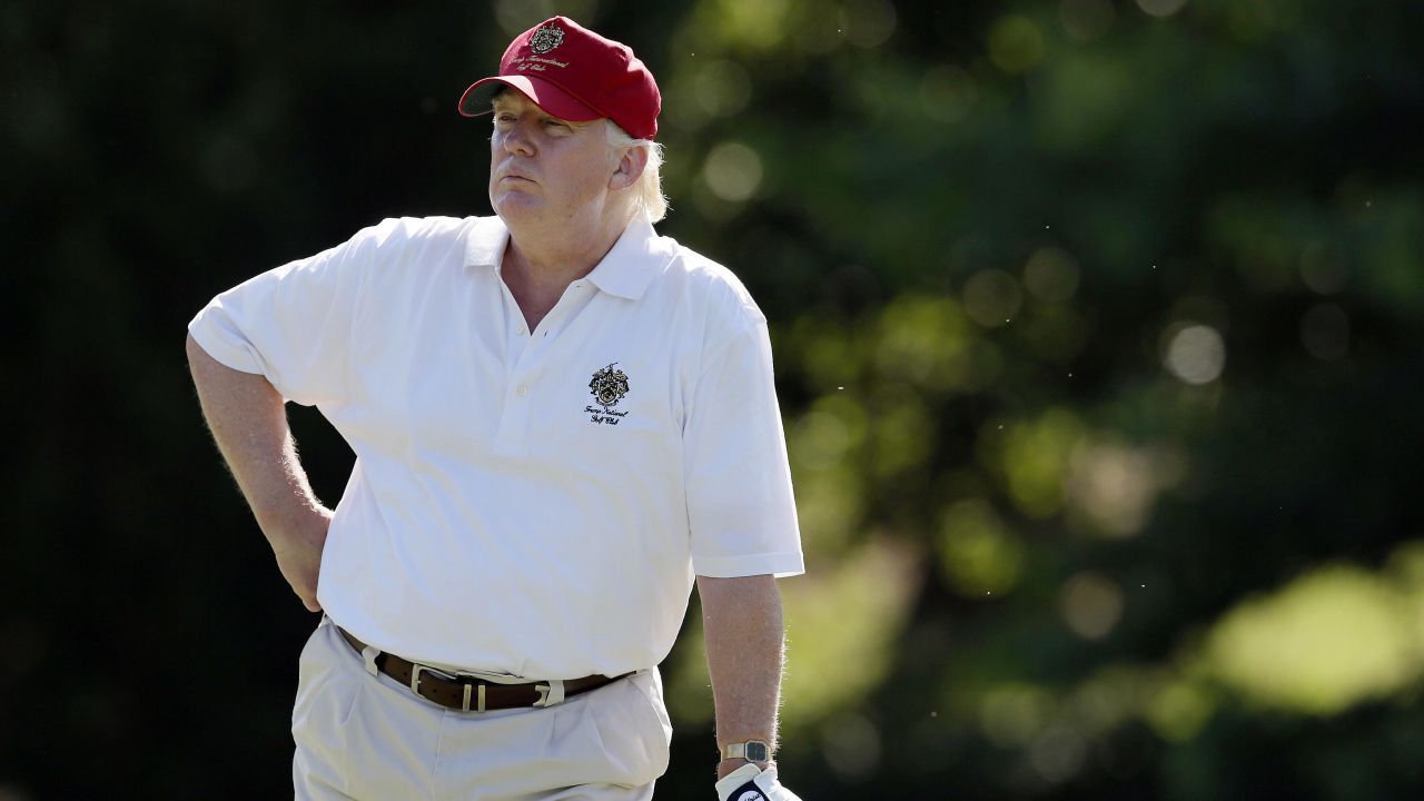 FILE - In this June 27, 2012, file photo, Donald Trump stands on the 14th fairway during a pro-am round of the AT&T National golf tournament at Congressional Country Club in Bethesda, Md. A set of golf clubs that Trump gifted to a former caddie before becoming president is being auctioned off. Boston-based RR Auction says Trump used the TaylorMade RAC TP ForgedIrons clubs at the Trump National Golf Club in Bedminster, New Jersey. (AP Photo/Patrick Semansky, File)