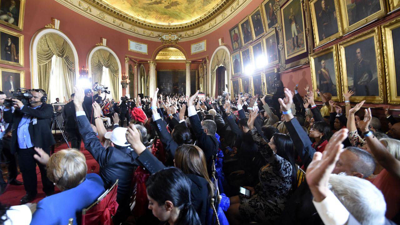 Members of the Constituent Assembly rise their hands during the Assembly's installation Friday in the capital, Caracas.