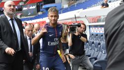 PARIS, FRANCE - AUGUST 04:  Neymar salutes the press after he posed with his new jersey after a press conference with Paris Saint-Germain President Nasser Al-Khelaifi on August 4, 2017 in Paris, France.  Neymar signed a 5 year contract for 222 Million Euro.  (Photo by Aurelien Meunier/Getty Images)