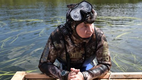 Putin takes a dip in a camouflage dive suit during his vacation this week in Siberia. 