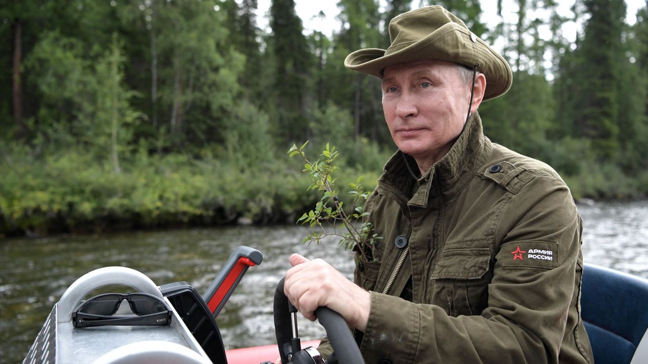 Putin guides a boat this week during his Siberian vacation.