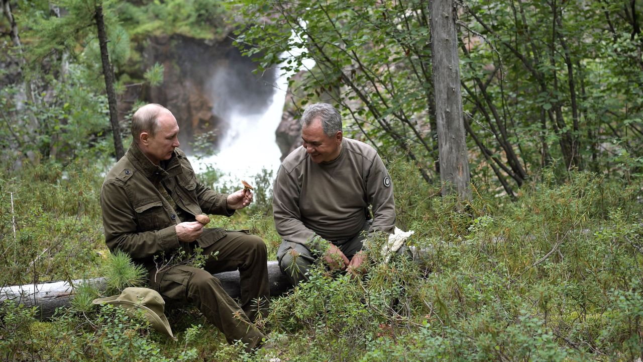 Russian President Vladimir Putin, left, shows mushrooms to Defense Minister Sergei Shoigu during his vacation this week in the remote Tuva region of southern Siberia.